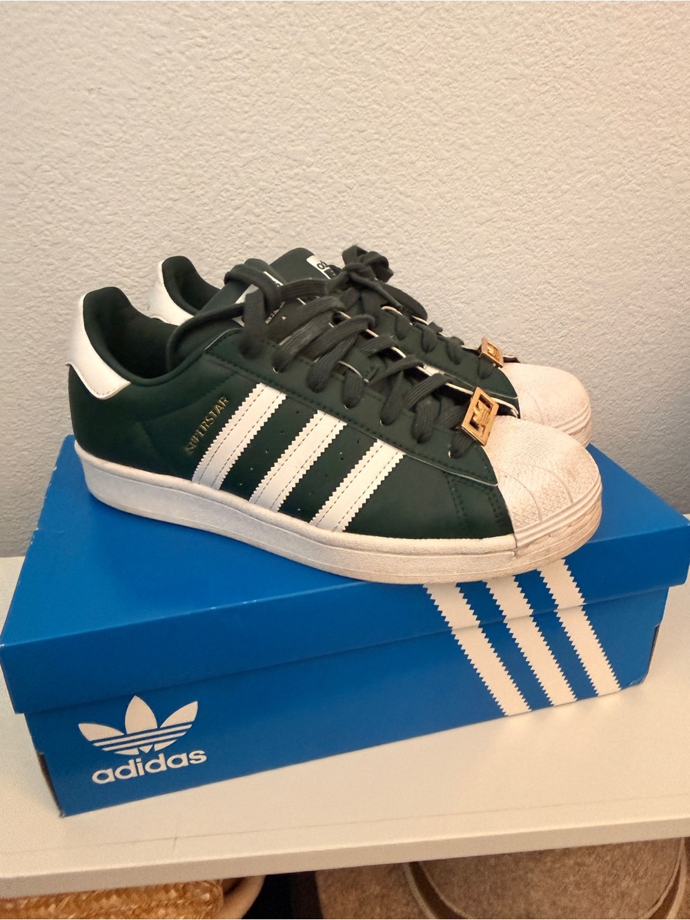 ADIDAS women’s Superstar Sneakers in Green and White with Gold Lace Tags